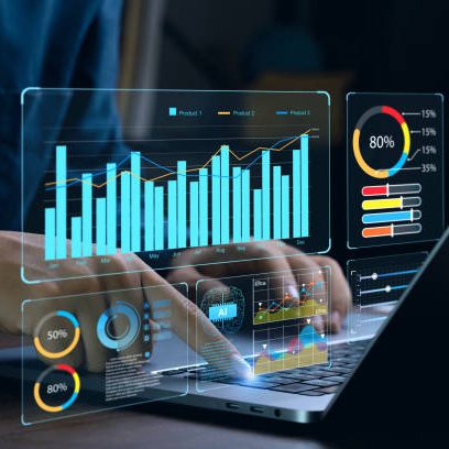 Hands interacting with a laptop displaying digital charts and graphs.