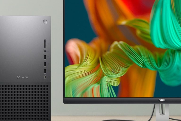 Close-up of a sleek computer tower next to a vibrant, colorful monitor display.