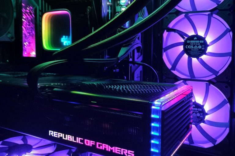 Close-up of a high-performance gaming PC with colorful RGB lighting and a Republic of Gamers logo.