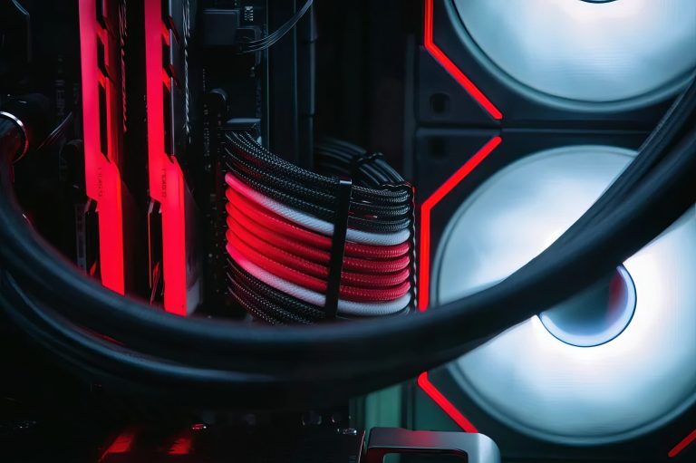 Close-up of a computer cooling system with red and white LED lights.